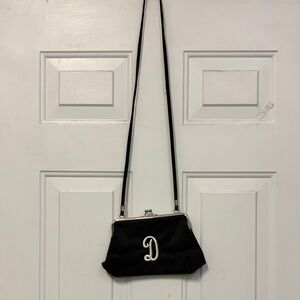 New Initial Inc Elegant Black Handbag with D embroidered on it